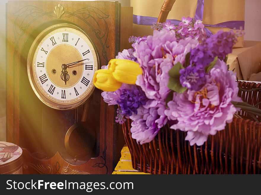 Spring photo with retro clock flowers in a basket a box of gifts tulips. Spring photo with retro clock flowers in a basket a box of gifts tulips