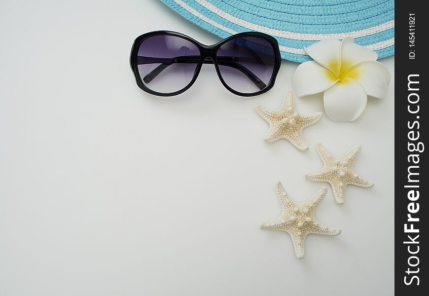 Summer beach dress items - shells, starfish, sunglasses, straw hats on a white background For pictures, travel, holidays and travel. Flat lay, top view. Summer beach dress items - shells, starfish, sunglasses, straw hats on a white background For pictures, travel, holidays and travel. Flat lay, top view