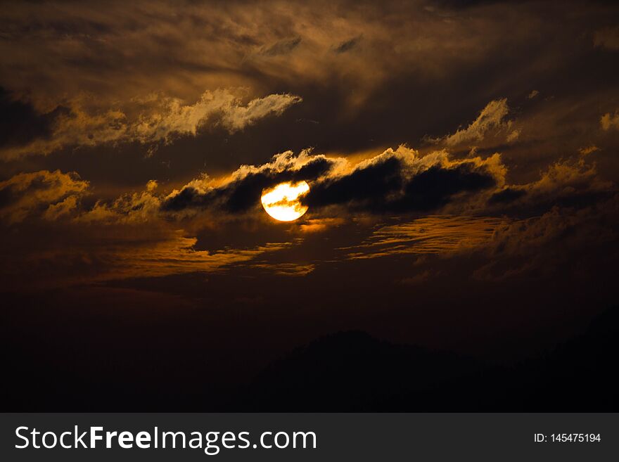 The evening Himalayan sky is ablaze with sunlight from behind the clouds