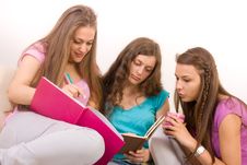 Three Young Girlfriends Sitting On Sofa Royalty Free Stock Photos