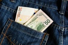 Euro And Dollar Banknotes In Jeans Pocket Royalty Free Stock Photography