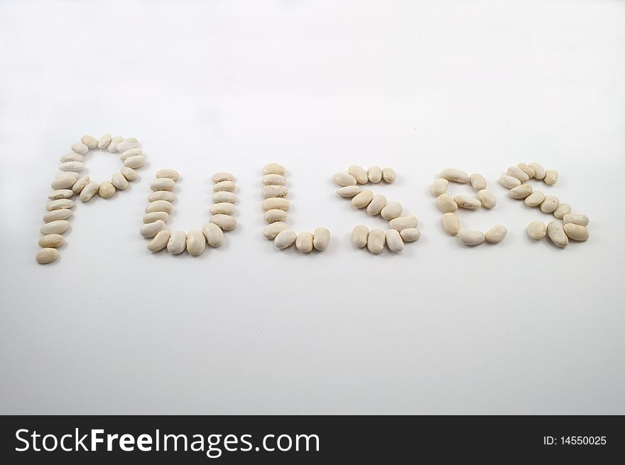 Pulses written in words using haricot beans on white background. Pulses written in words using haricot beans on white background.