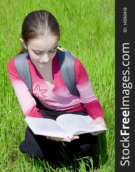 Girl with book. Studying on nature.