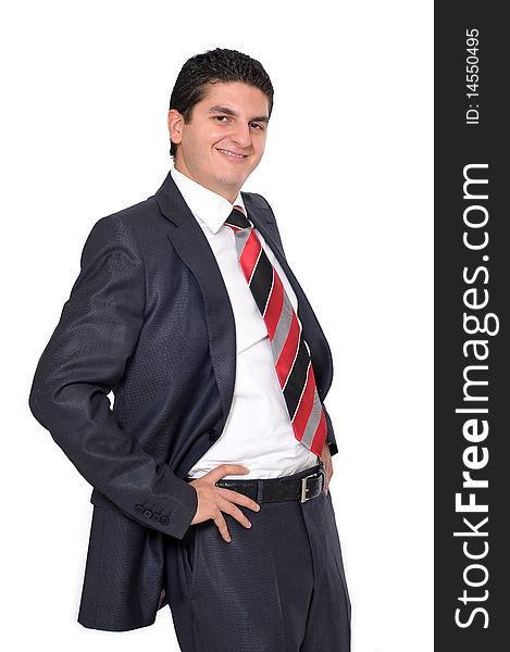 A young businessman smiling with his hands on his hips. A young businessman smiling with his hands on his hips.