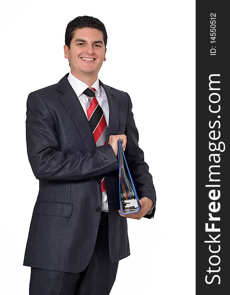 A young smiling businessman holding a binder full of files.