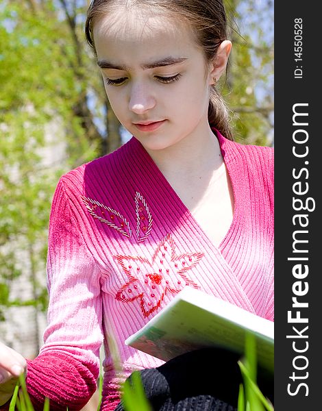 Girl with book. Studying on nature.