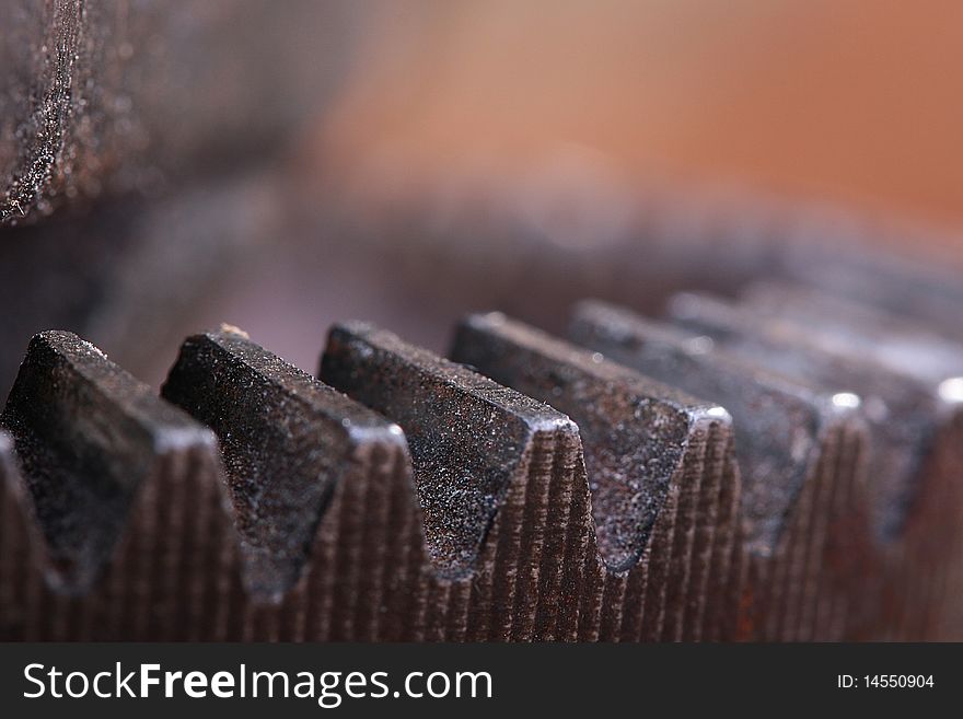 Mechanical workshop, teeth of an old gear wheel close up.