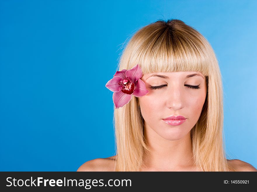 Young pretty girl with flower in hair portrait. Young pretty girl with flower in hair portrait