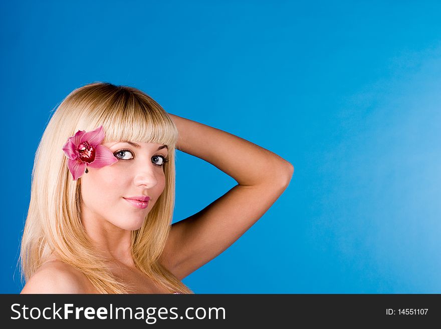 Portrait of a beautiful blond lady on a blue background. Portrait of a beautiful blond lady on a blue background
