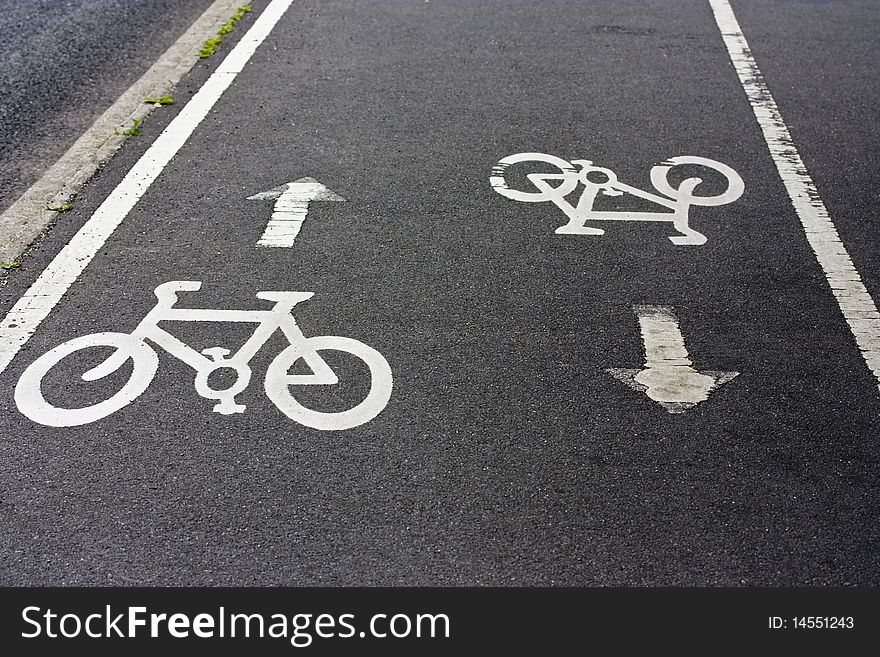 a cycle path with two bikes painted on it. a cycle path with two bikes painted on it