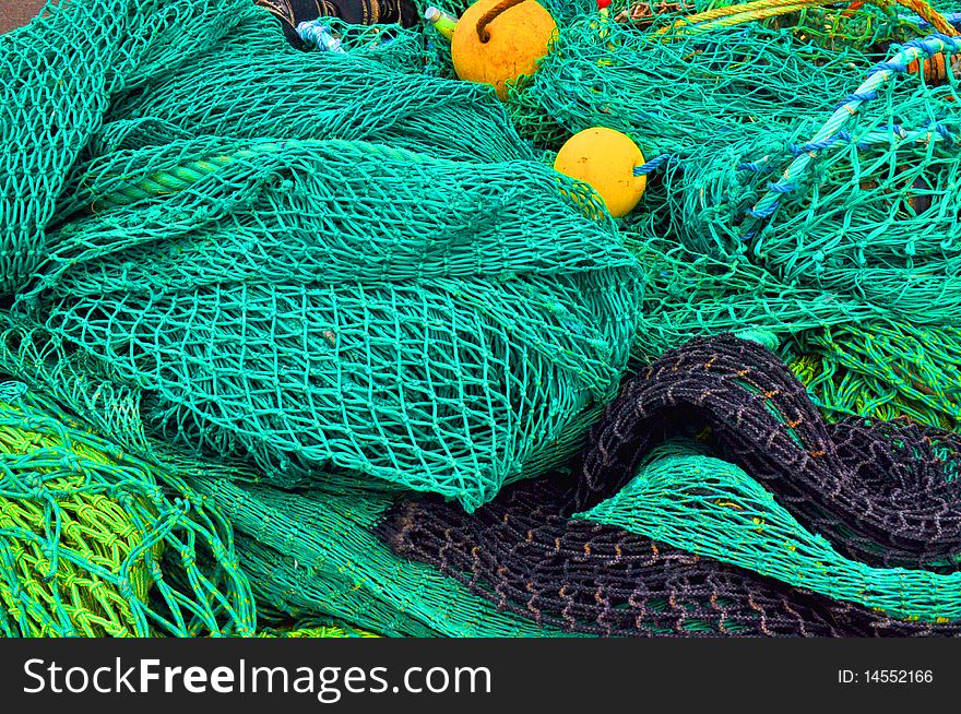 Close up of green fishing nets on dock