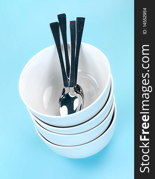 Plates and cutlery isolated against a blue background