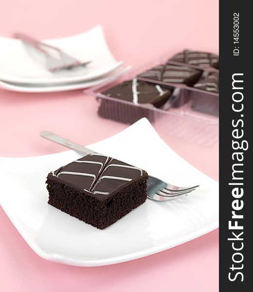 Chocolate mud cake slices isolated against a pink background