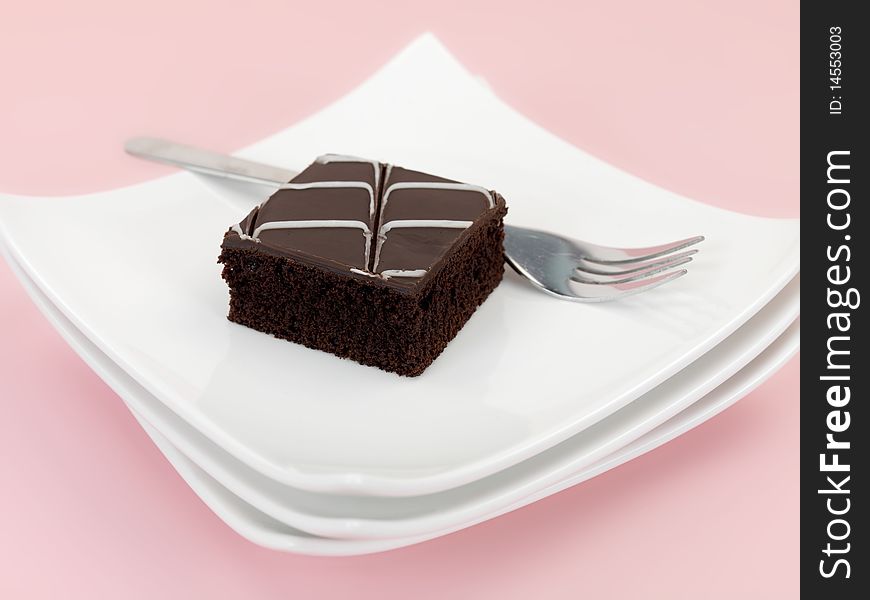 Chocolate mud cake slices isolated against a pink background