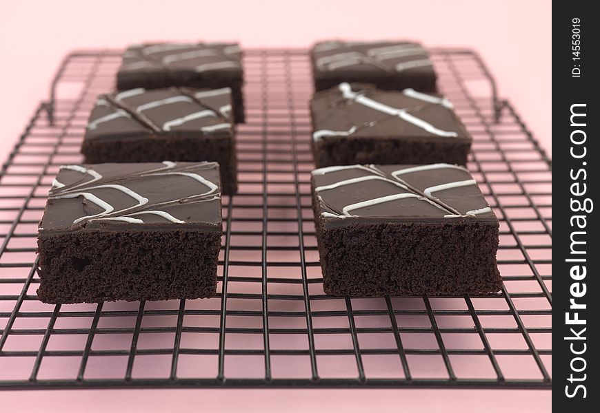 Chocolate mud cake slices isolated against a pink background