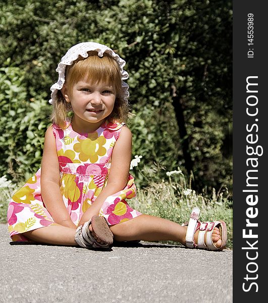 Cute little girl sit in pink dress