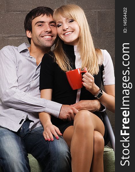 Young cheerful couple on brick wall background