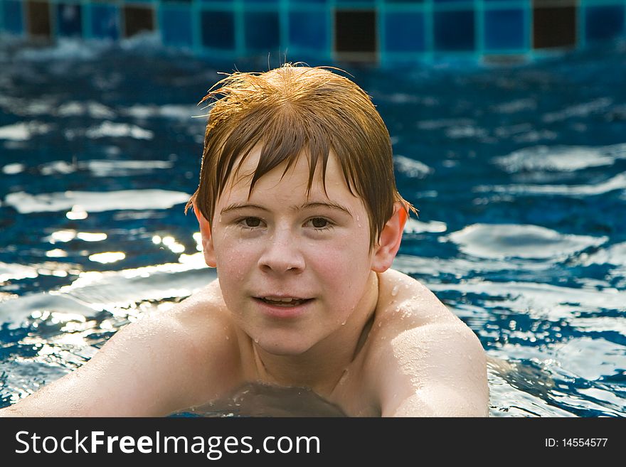 Boy With Red Hair In Pool