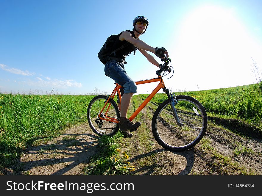 Dynamic composition with cyclist; warm lighting setup; attention - main focus is on the wheel and not on the face!. Dynamic composition with cyclist; warm lighting setup; attention - main focus is on the wheel and not on the face!