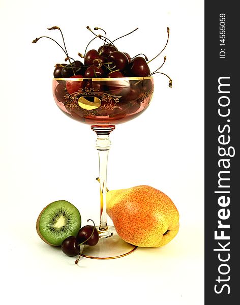 Still-life of kiwi, pear and cherry isolated