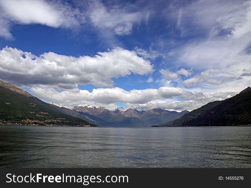 Scene of snow topped Treviso mountains at Lake Como in Italy