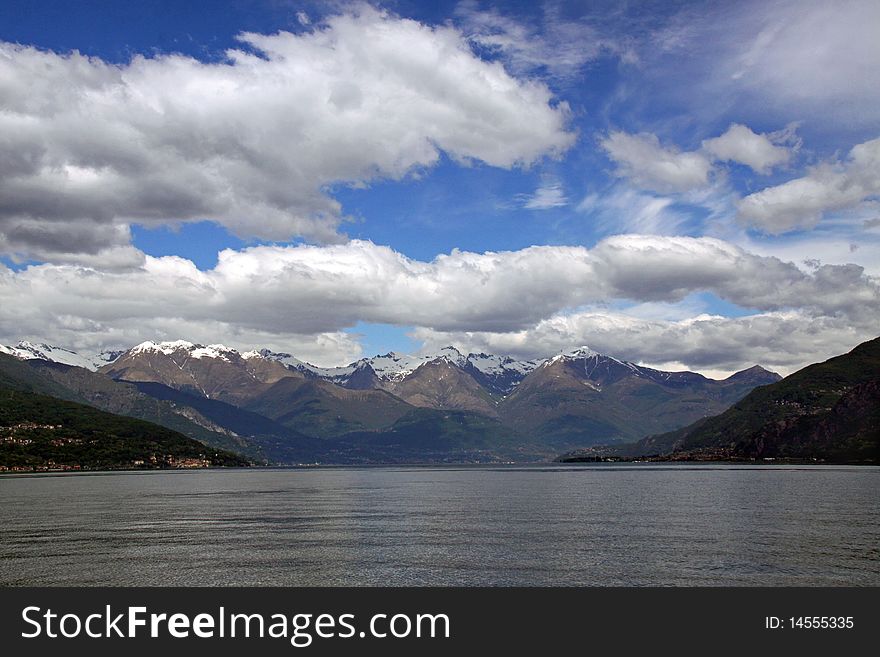 Scene of snow topped Treviso mountains at Lake Como in Italy