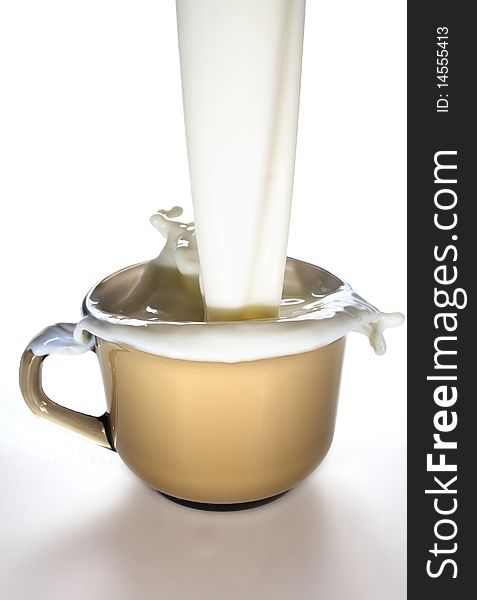 Milk is poured into a glass mug