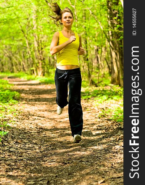 Young woman running in forest. Young woman running in forest