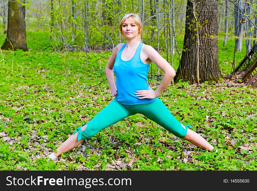 Young woman doing exercises in park. Young woman doing exercises in park