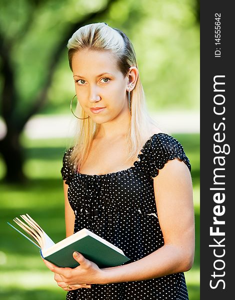 Girl with book in park