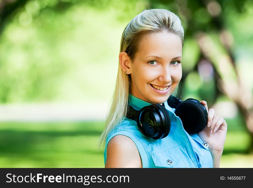 Girl with headphones in park