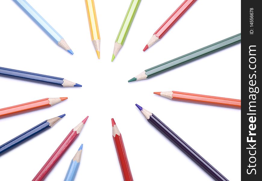 Several color pencils pointing at the same empty spot. Several color pencils pointing at the same empty spot.