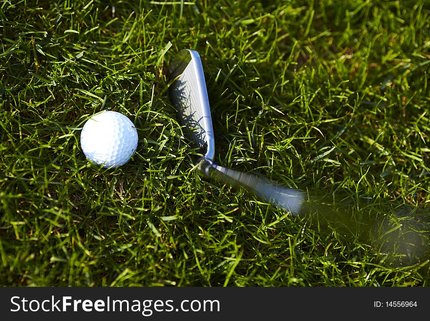 Golf ball with golf club off the green. Golf ball with golf club off the green.