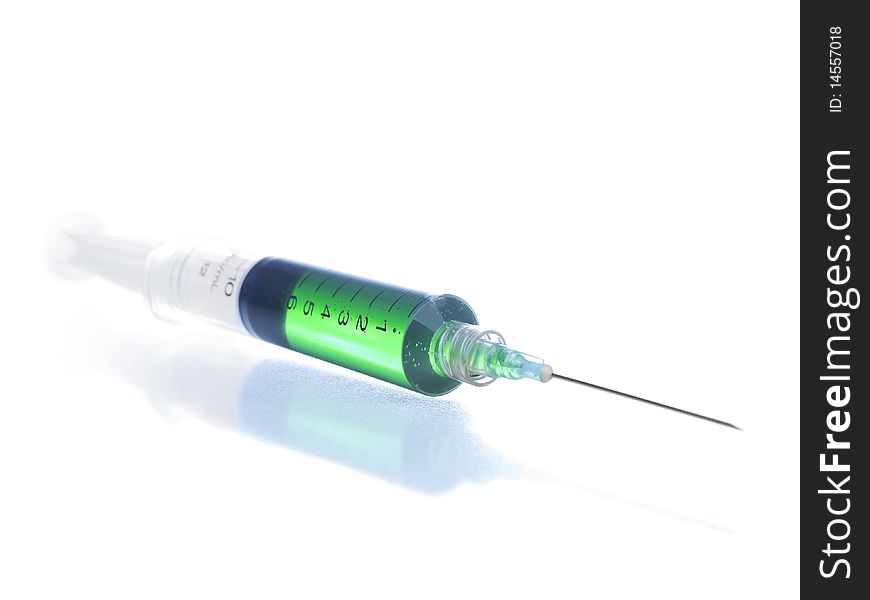 Close up on a syringe filled in with a green liquid. Close up on a syringe filled in with a green liquid.