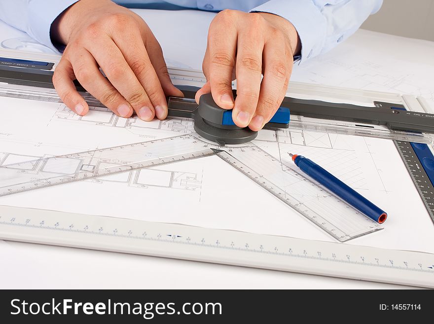 Architect working on architectural plans in the office