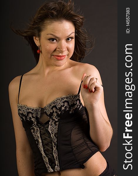 Sexy glamorous girl in corset isolated on black background