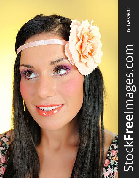 Young beautiful woman face with creayive eye make-up and flower band in the hair. Young beautiful woman face with creayive eye make-up and flower band in the hair