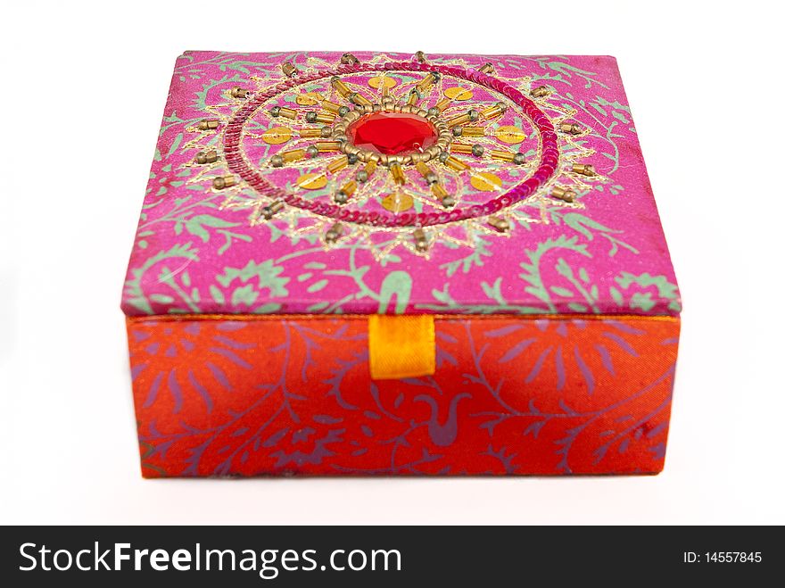 Square, red jewellery box with intriquite patterns and designs covering it. Square, red jewellery box with intriquite patterns and designs covering it