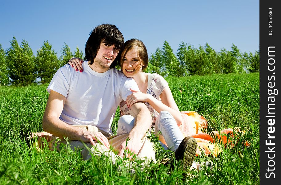 Beautiful girl with smile and boy on grass. Beautiful girl with smile and boy on grass