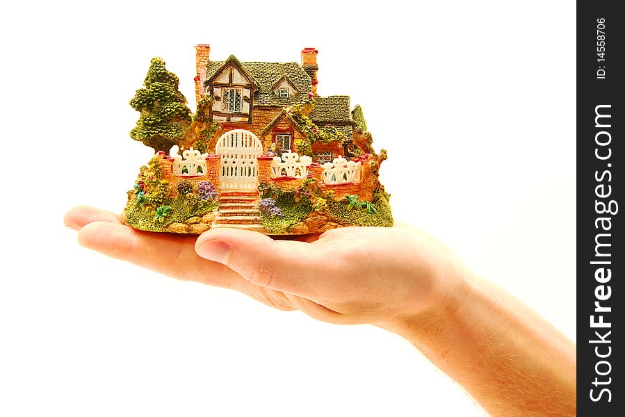 Man holding a small house in hands