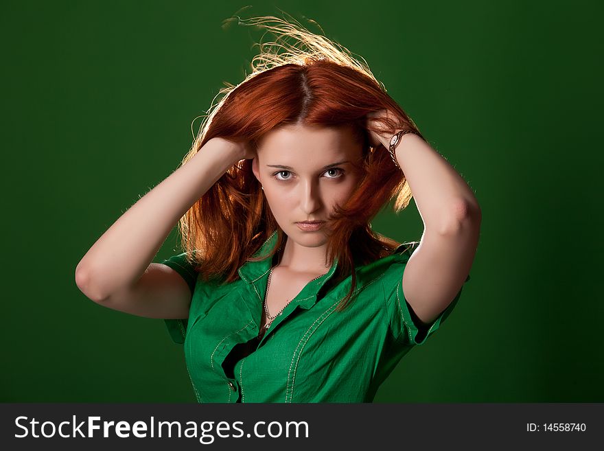 Young beautiful red-haired woman on studio bakground. Young beautiful red-haired woman on studio bakground