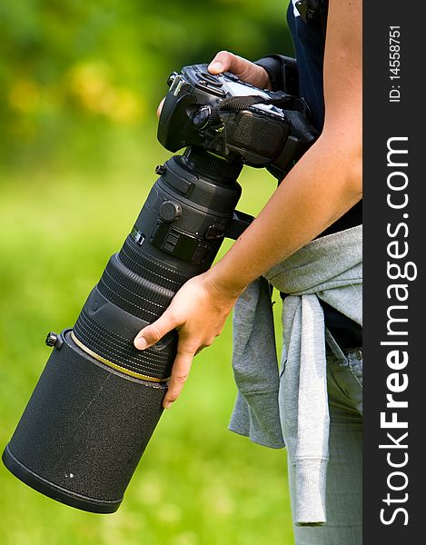 Professional camera outdoor in a woman hands