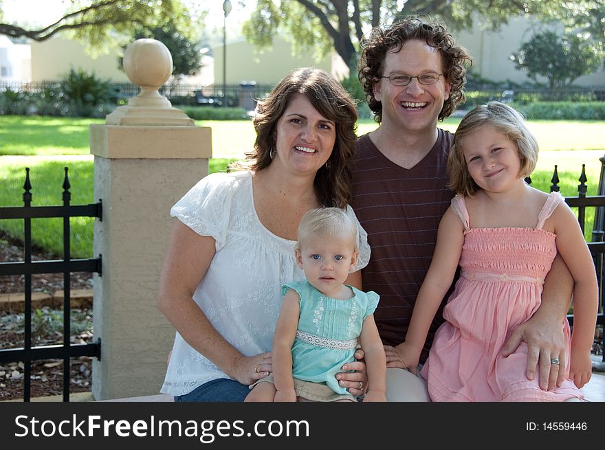 Family sits on a park bench