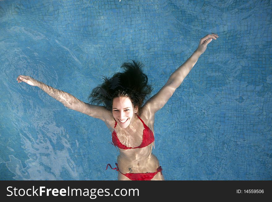 Beautiful woman floating on swimming pool. Beautiful woman floating on swimming pool