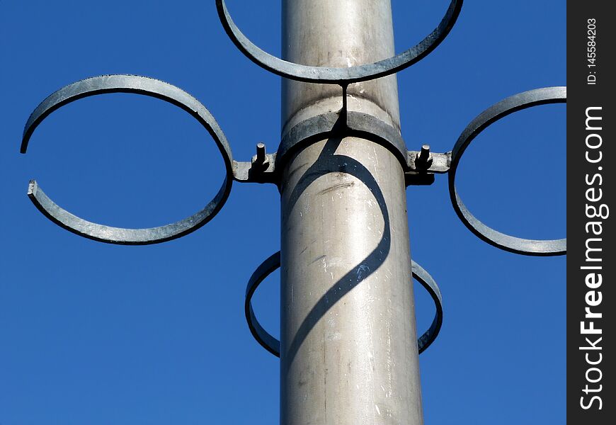 Empty steel rings of flower pot holders on aluminum pole
