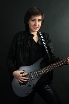 Rock Girl In Leather Outfit With Electric Guitar Stock Photos
