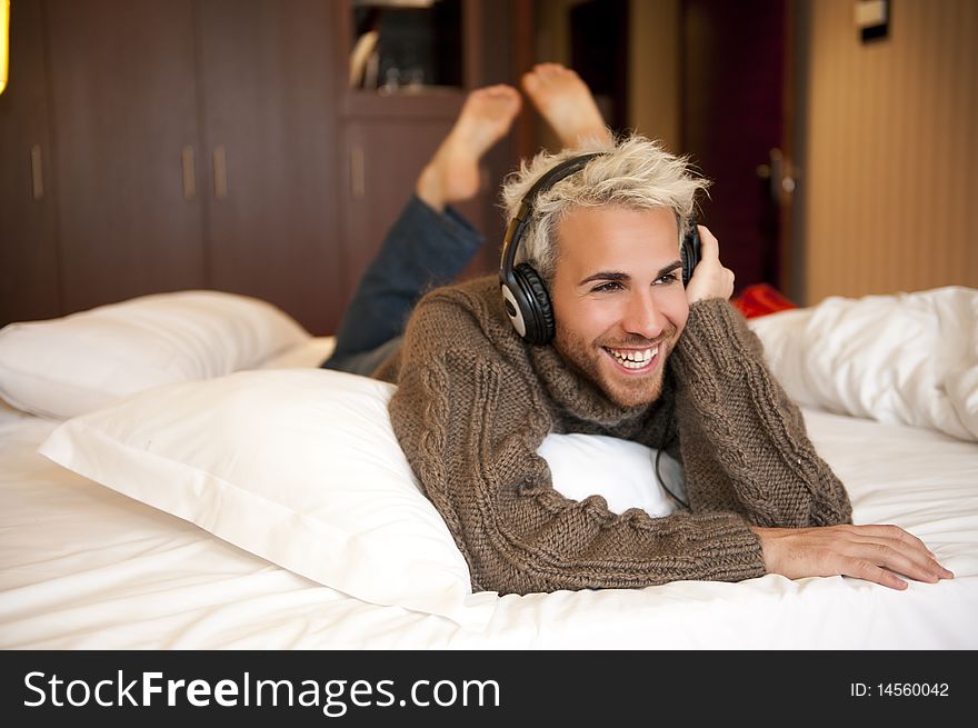 Man listening music with headphones at home.