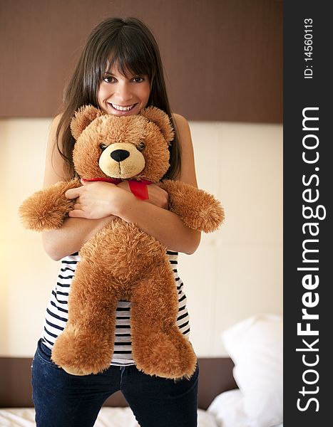 Young woman with teddy bear in bed. Young woman with teddy bear in bed