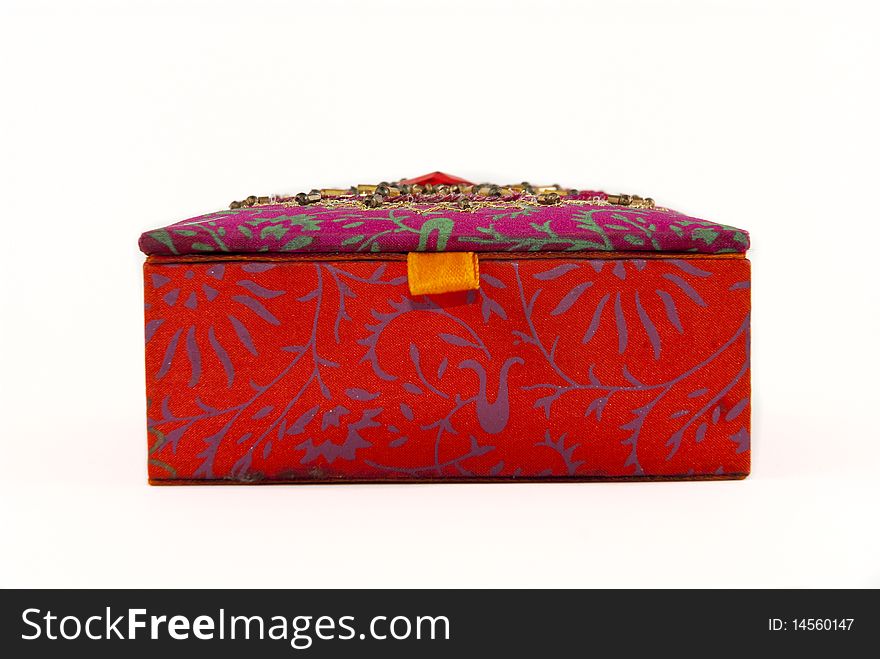 Square, red jewellery box with intriquite patterns and designs covering it. Square, red jewellery box with intriquite patterns and designs covering it