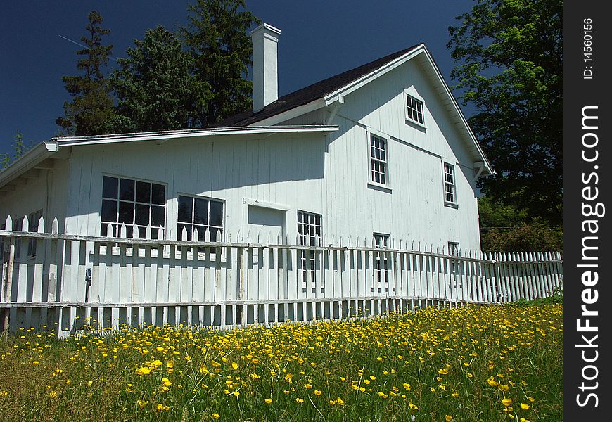 White house and fence with flowers. White house and fence with flowers